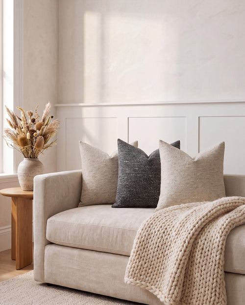 Nassjo cushions in beige and charcoal on a linen sofa