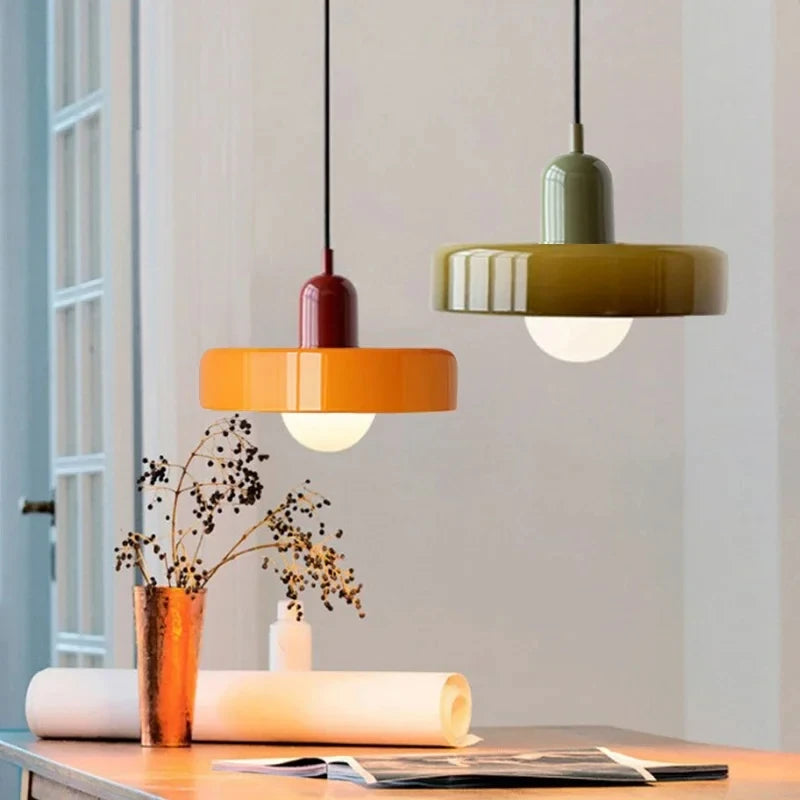 Oakhampton pendant lights in olive and orange above a dining table