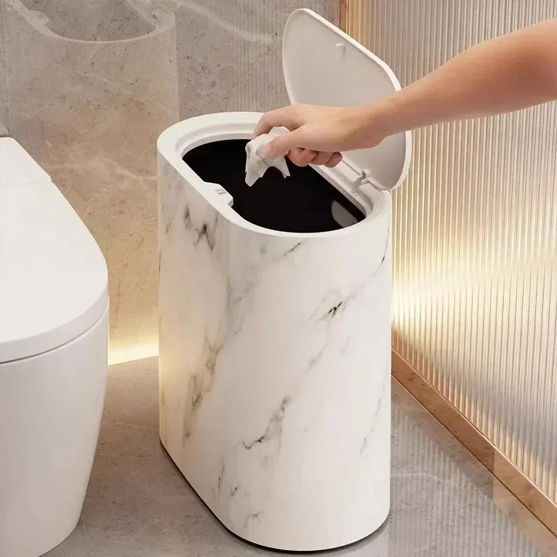 White marble-effect bin with press lid open in a bathroom