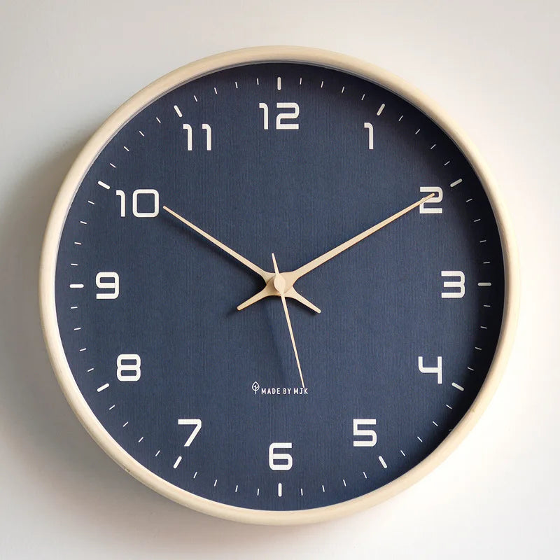 Wooden wall clock with blue face on a plain wall