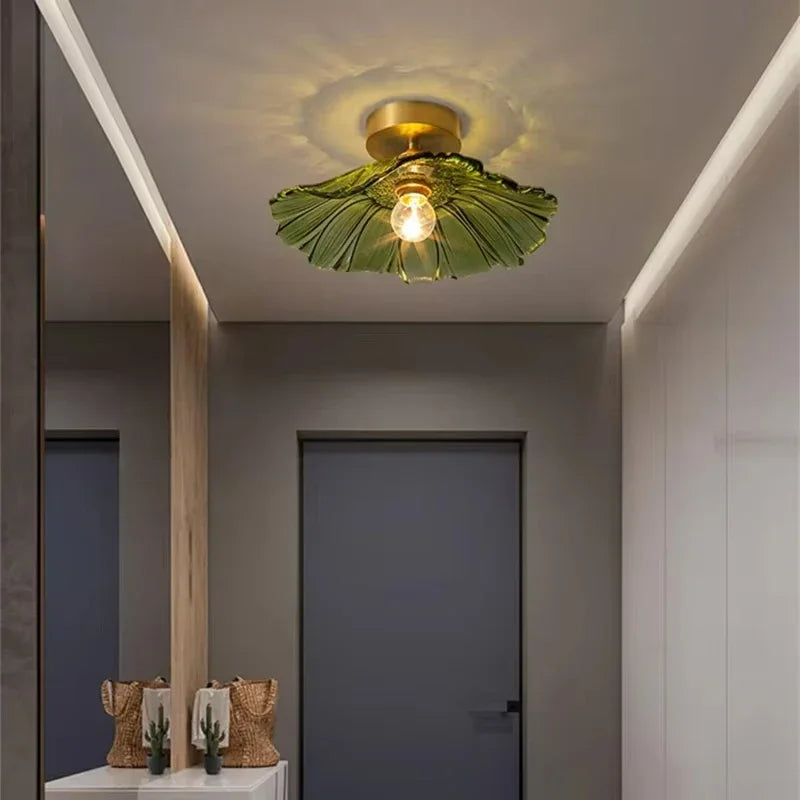 Melford green glass ceiling light lit in an entrance hall