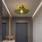 Melford green glass ceiling light lit in an entrance hall