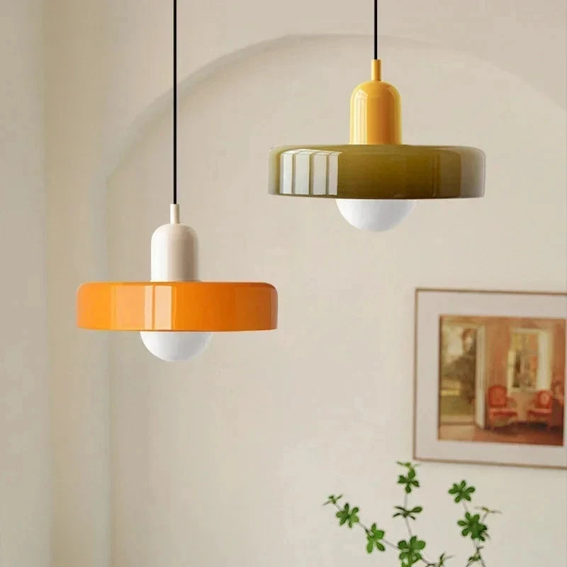 Oakhampton pendants hung at two heights against a plaster wall