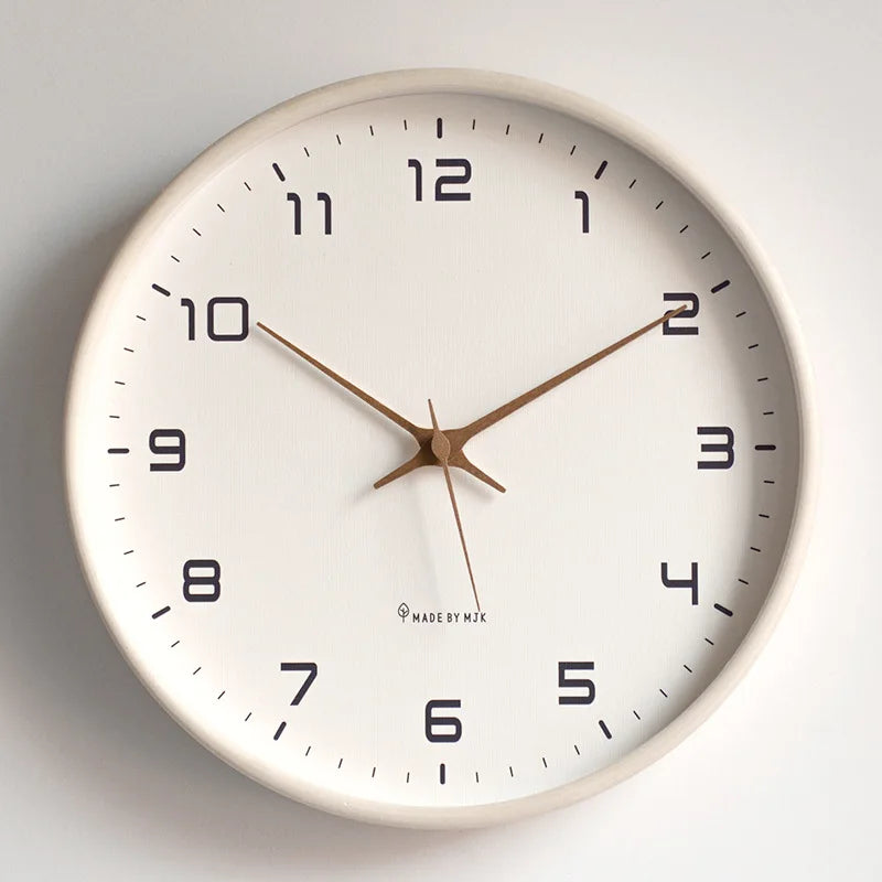 White wood wall clock with white face on a plain wall