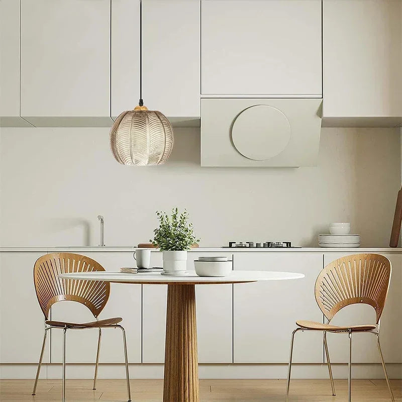 Quenby amber glass pendant hung above a round kitchen table