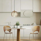 Quenby amber glass pendant hung above a round kitchen table