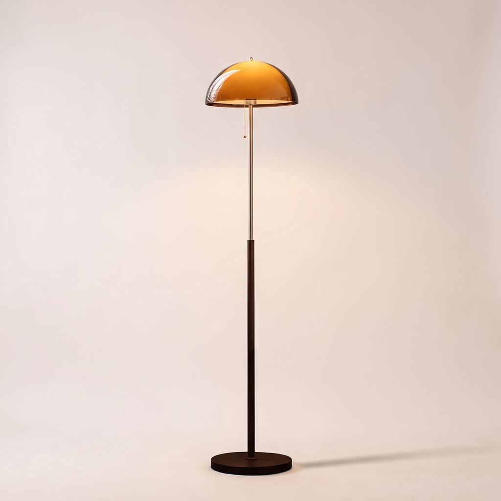 Aalen amber dome mushroom floor lamp switched on, on a light studio background