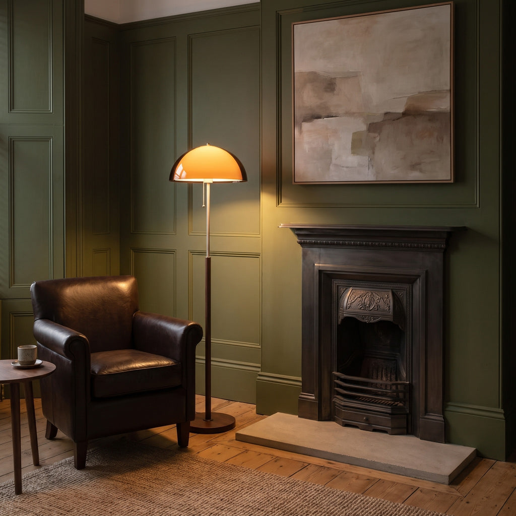 Aalen amber floor lamp lit beside a leather club chair in an olive green Victorian sitting room