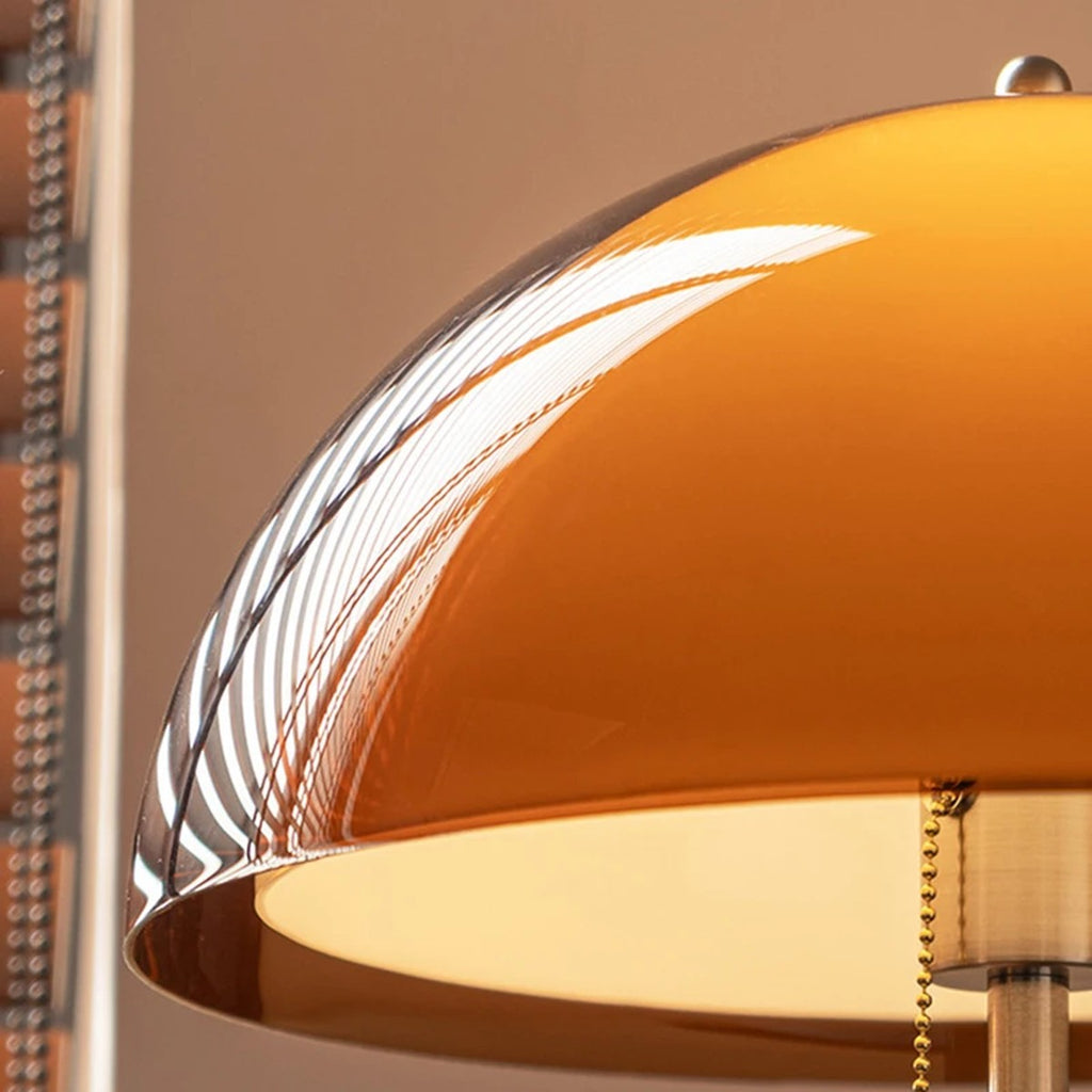 Close up of the Aalen amber acrylic dome shade glowing