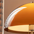 Close up of the Aalen amber acrylic dome shade glowing