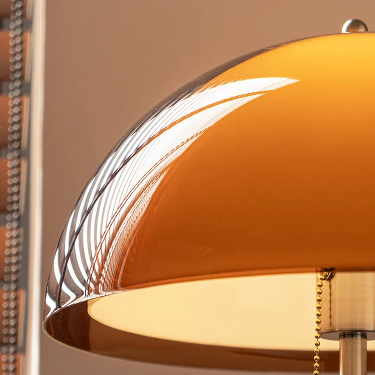 Close up of the Aalen amber acrylic dome shade glowing