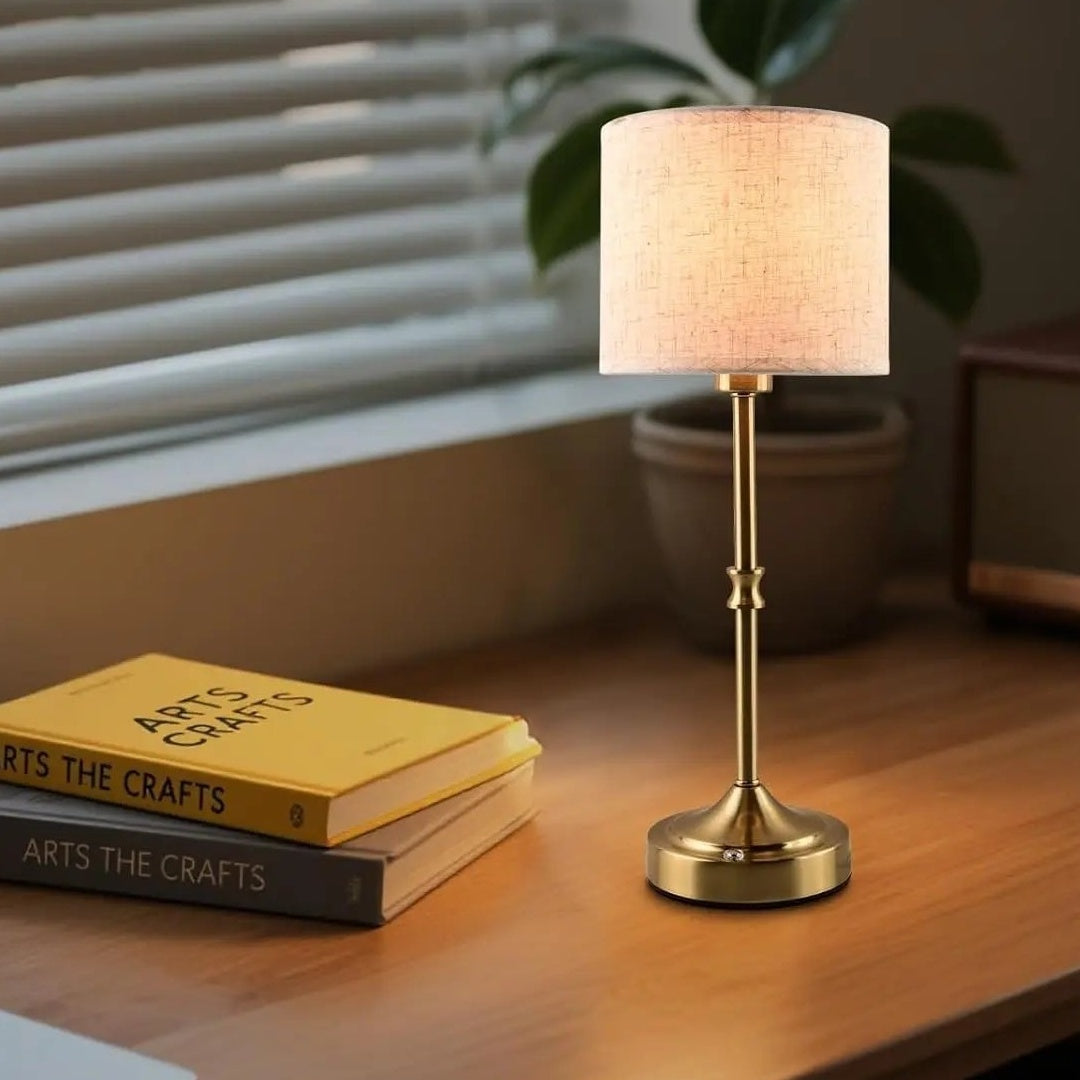 Cordless table lamp with fabric drum shade on a desk, Allinge