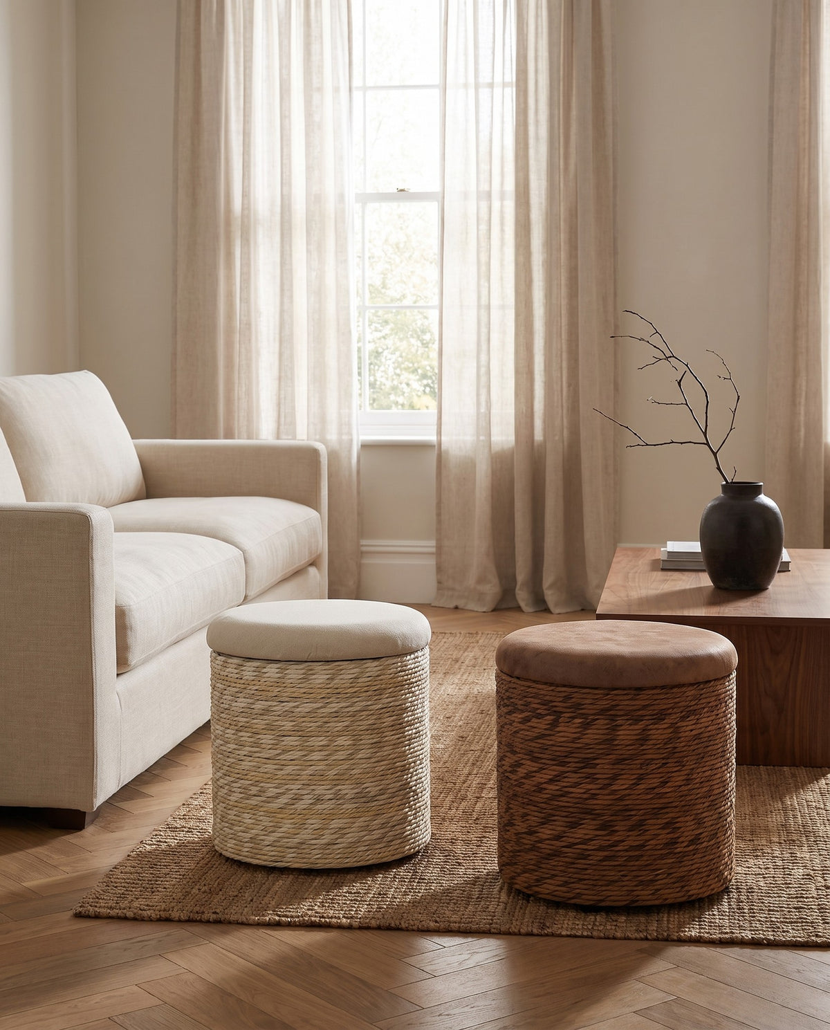 Natural and Coffee Brown Amrum storage stools side by side in a living room, each sold individually