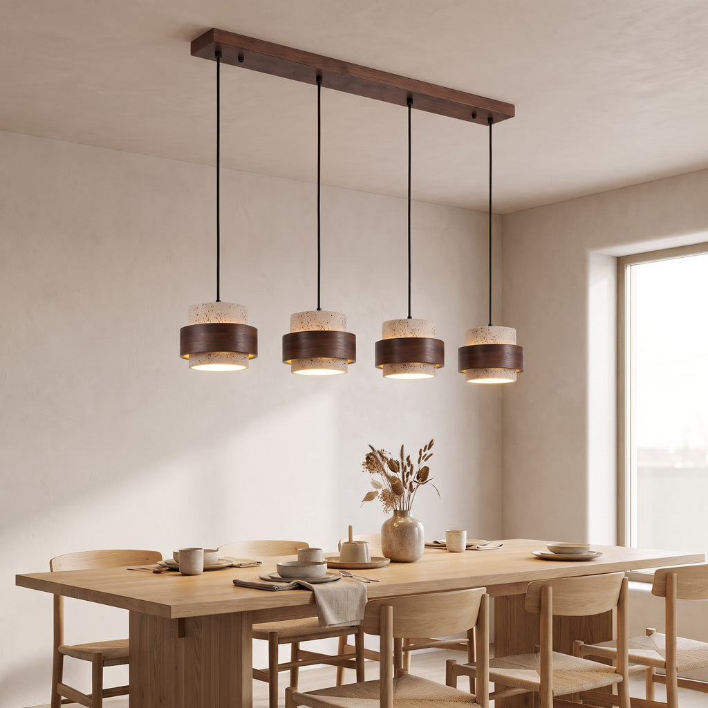 Bregenz four light bar pendant lit above a dining table