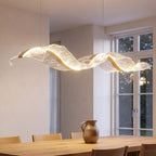 Binz wave pendant glowing over a dining table