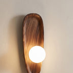Marstal wall light switched on, wood grain detail