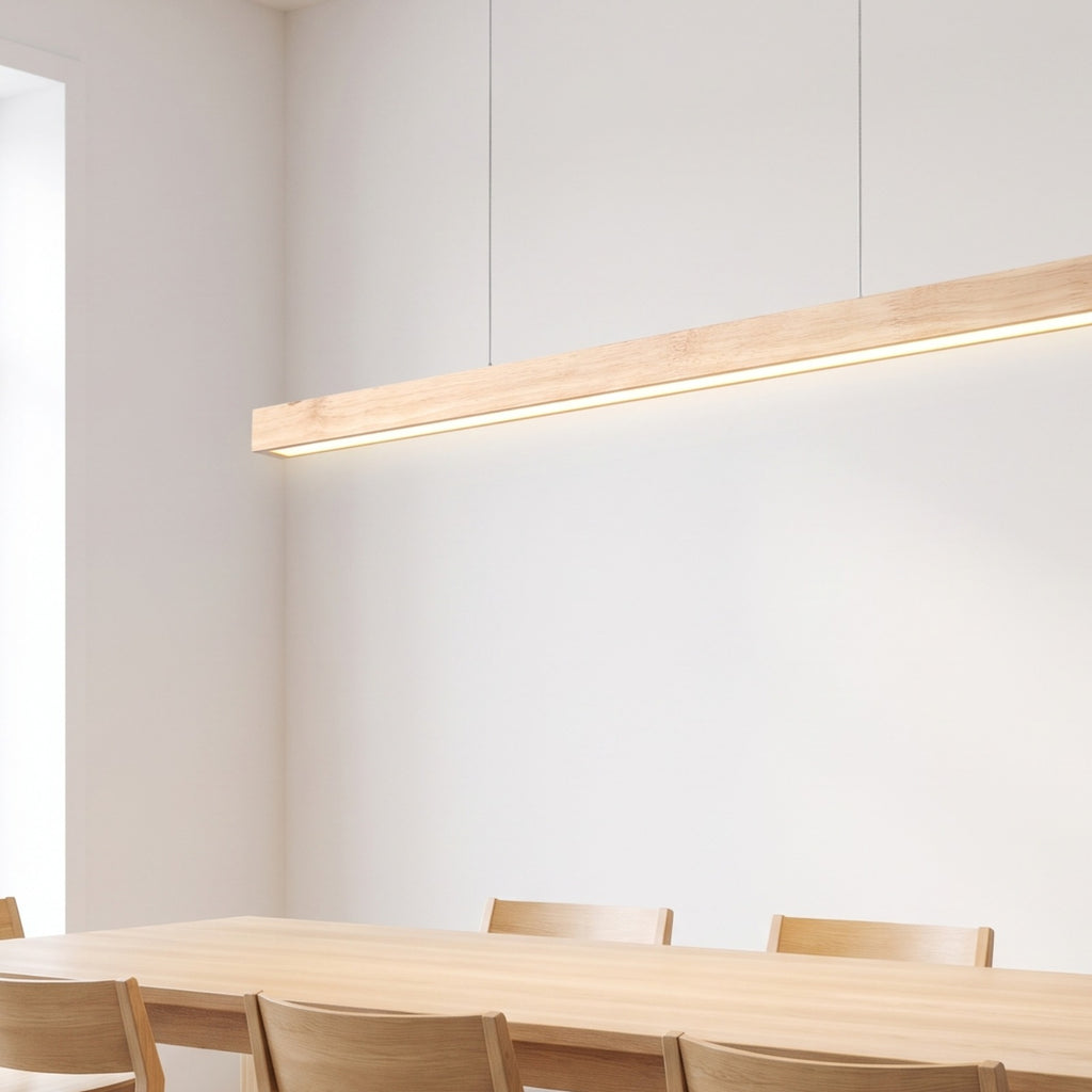 Hjo linear pendant lit over an oak table