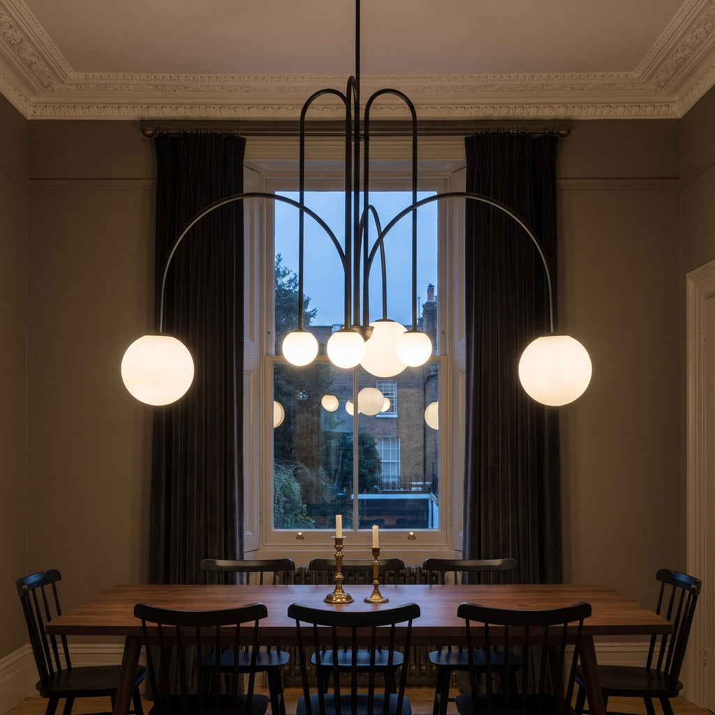 Eckernforde black chandelier lit over a walnut dining table in a Victorian dining room
