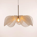 Fussen sheer fabric petal pendant light lit, on a light studio background