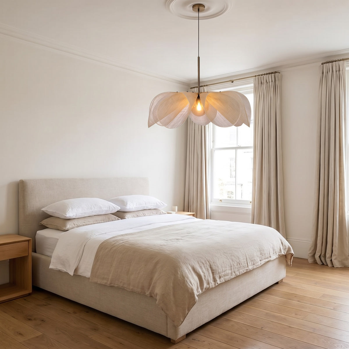 Fussen petal pendant hanging from a ceiling rose above a linen bed