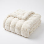 Gent ruched faux fur throw in cream, folded, on white