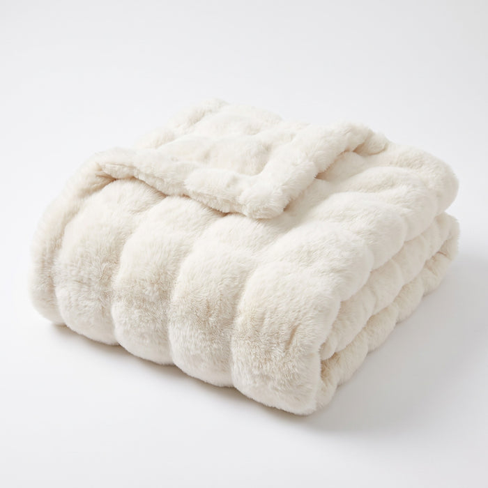 Gent ruched faux fur throw in cream, folded, on white