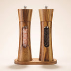 Grebbestad acacia salt and pepper mills on their acacia base on a light background