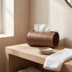 Haarlem tissue box holder on a pale oak bathroom shelf beside a soap dish