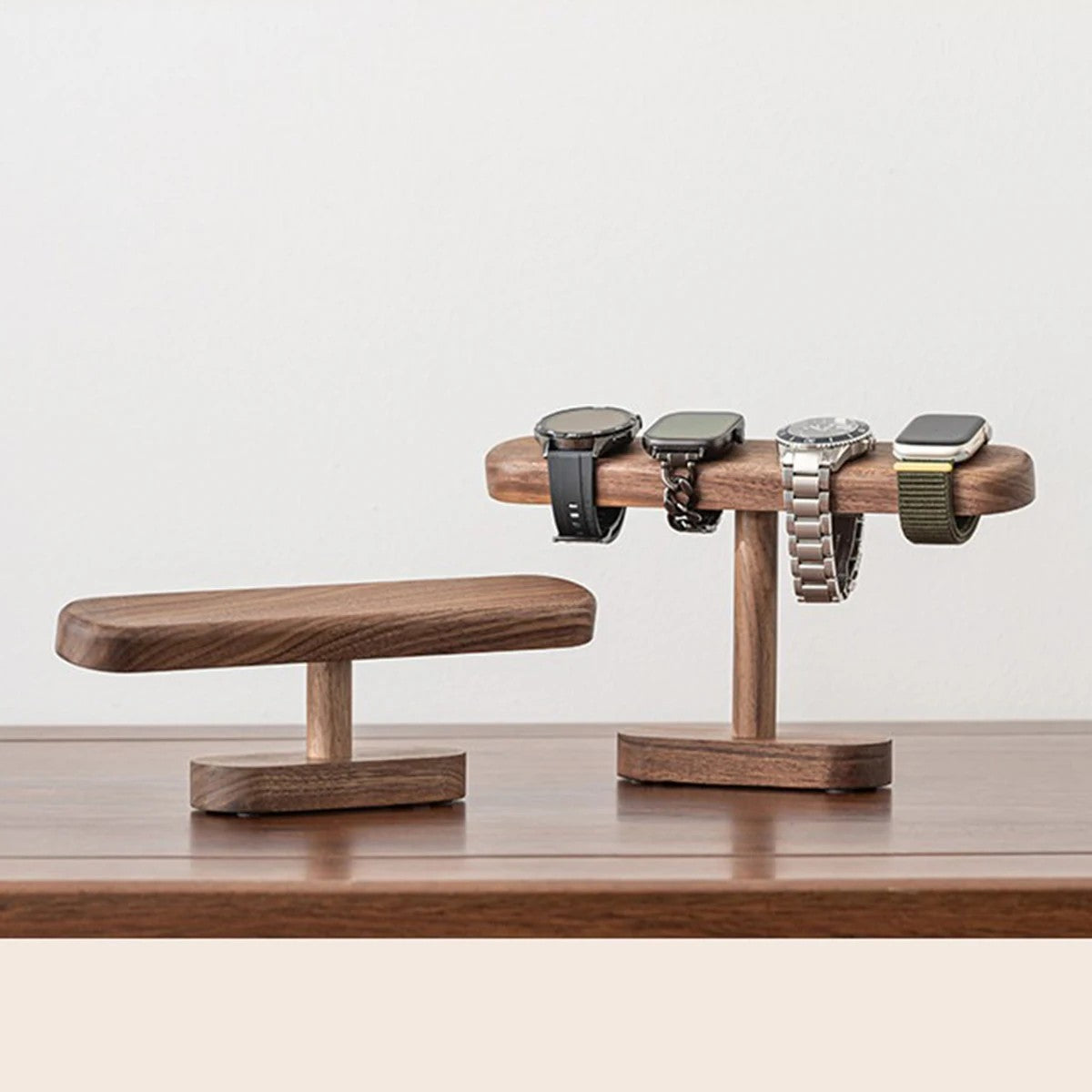 Low and tall Hagen walnut watch stands, the tall one holding four watches, product photo
