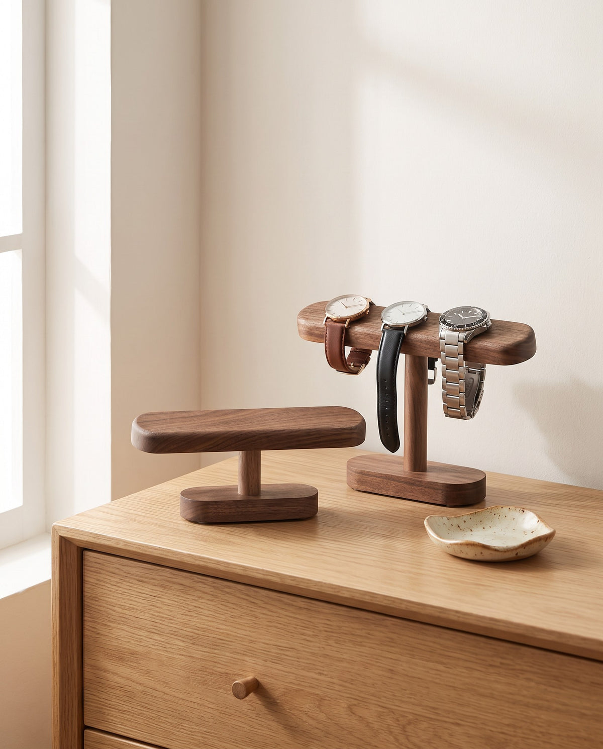 Hagen watch stands in both heights on an oak chest of drawers
