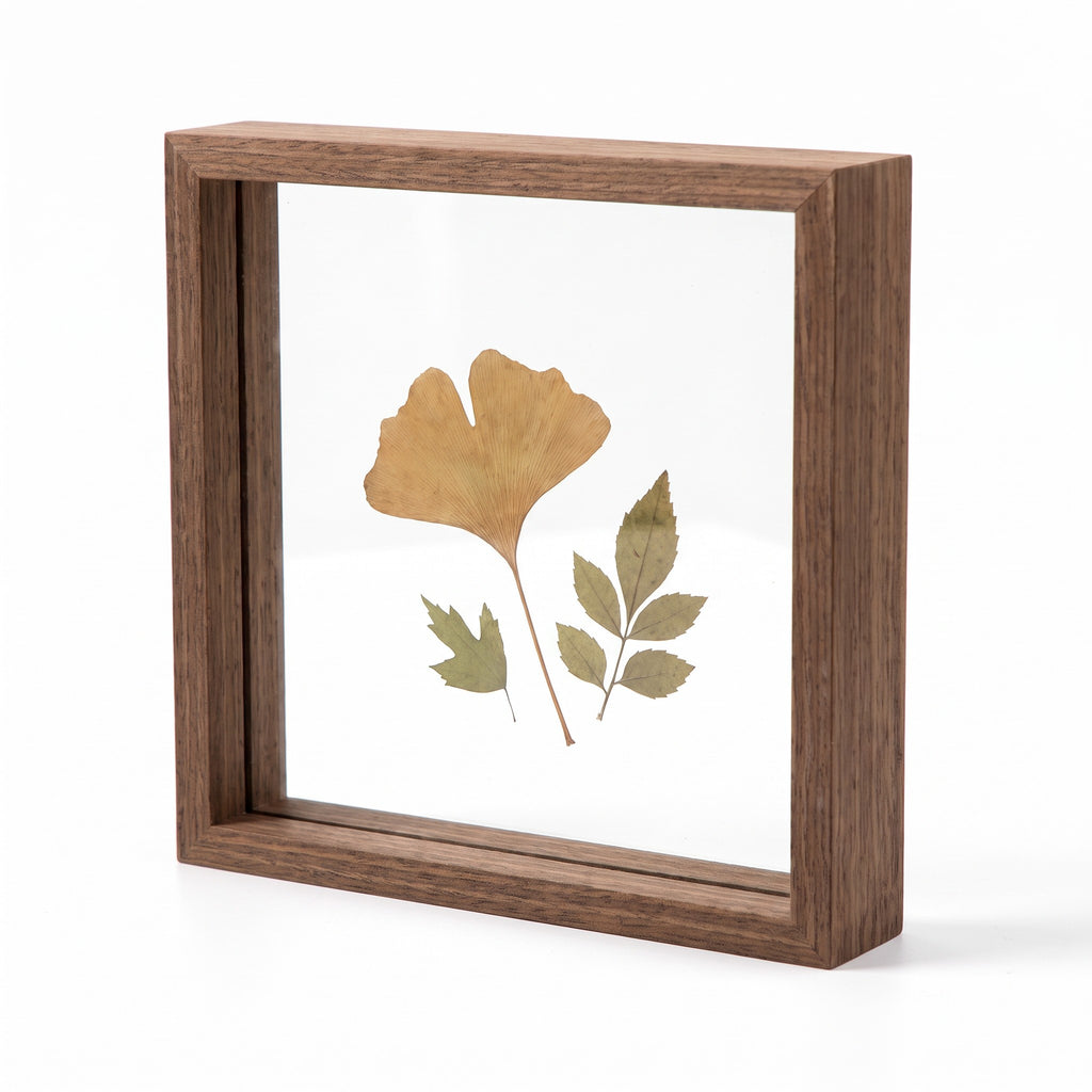 Hallstatt double glass floating frame in walnut tone with pressed leaves