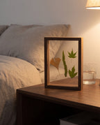 Hallstatt walnut tone floating frame on a bedside table