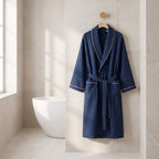 Heringsdorf Navy waffle robe hanging on an oak peg in a light bathroom