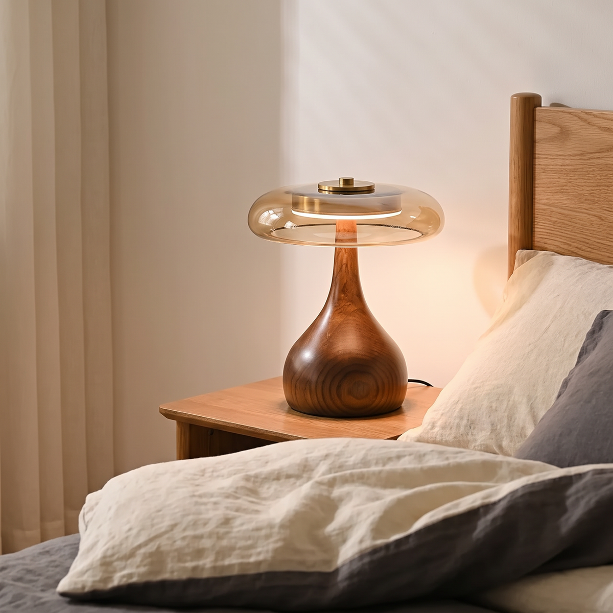 Thornbury lamp beside a bed with linen bedding