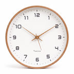 Wooden wall clock with white face on a white background