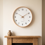 Wooden wall clock above an oak fireplace mantel