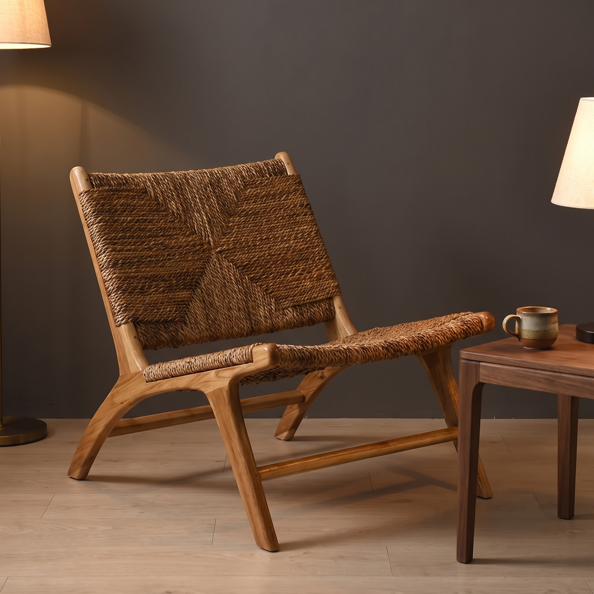Lavenham lounge chair beside a side table in the evening