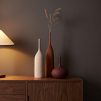 Farrow ceramic vase trio on a walnut sideboard at dusk