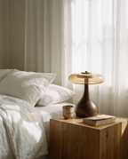 Thornbury amber glass table lamp on a bedside table in morning light