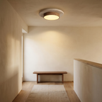 Tilbury travertine and walnut ceiling light lit above a landing