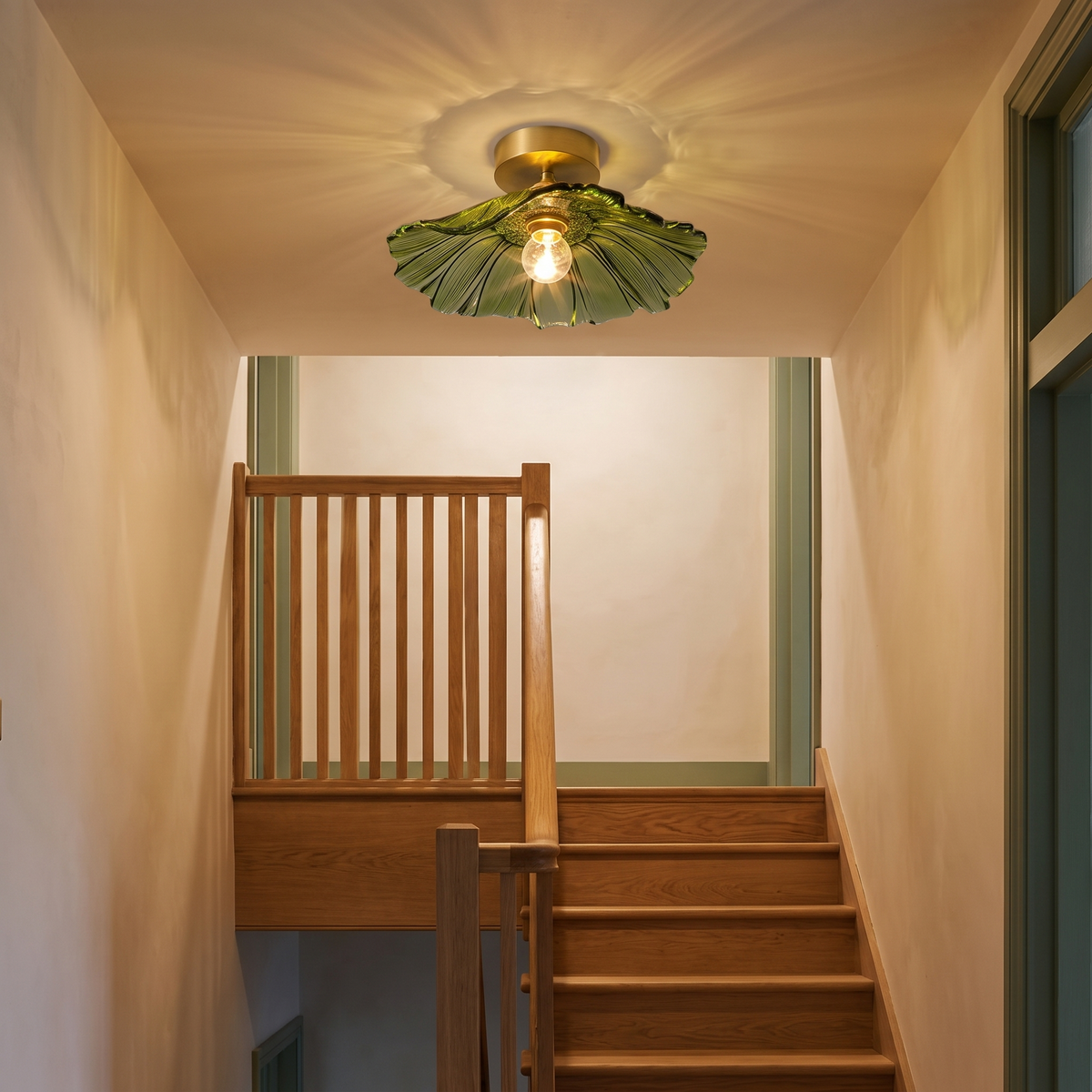 Melford green petal glass ceiling light at the top of an oak staircase