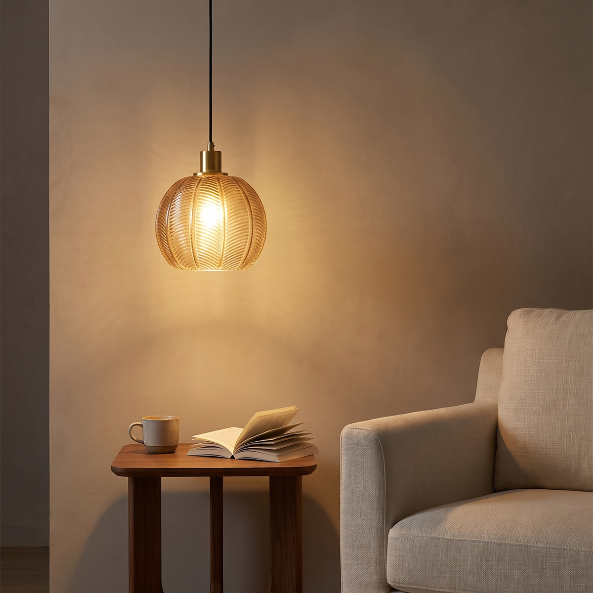 Quenby ribbed amber glass pendant light above a reading corner side table