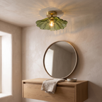 Melford green petal glass ceiling light above an oak vanity and round mirror