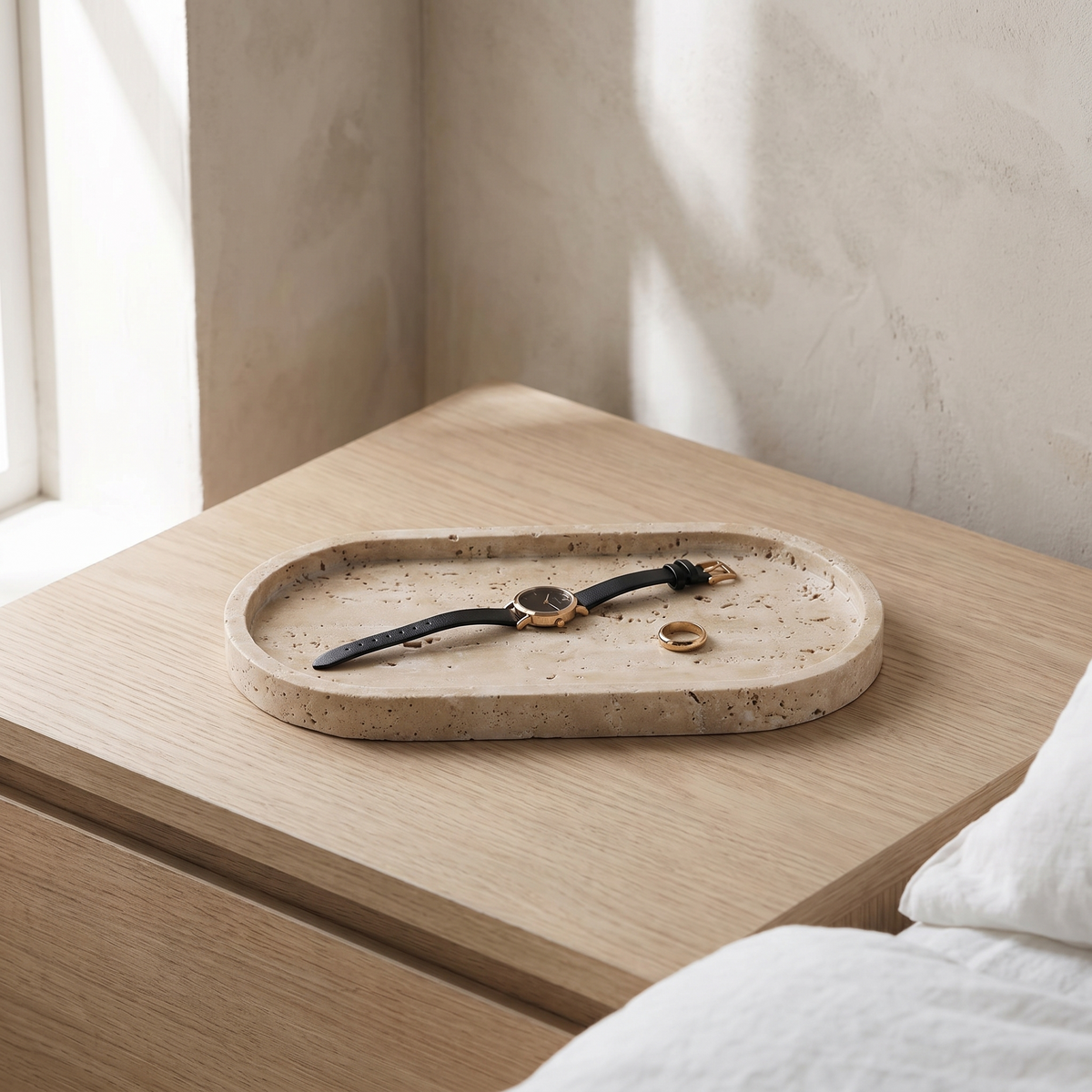 Ashby travertine tray on a pale oak bedside