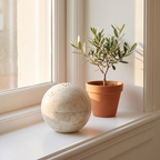 Tetbury travertine sphere on a white windowsill