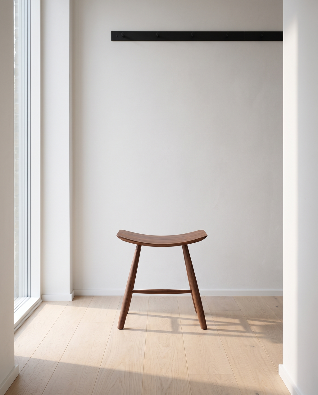 Herning saddle stool in a Scandinavian hallway