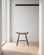 Herning saddle stool in a Scandinavian hallway