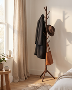 Goslar walnut coat stand in a bedroom corner