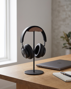 Marburg headphone stand holding headphones on an oak desk