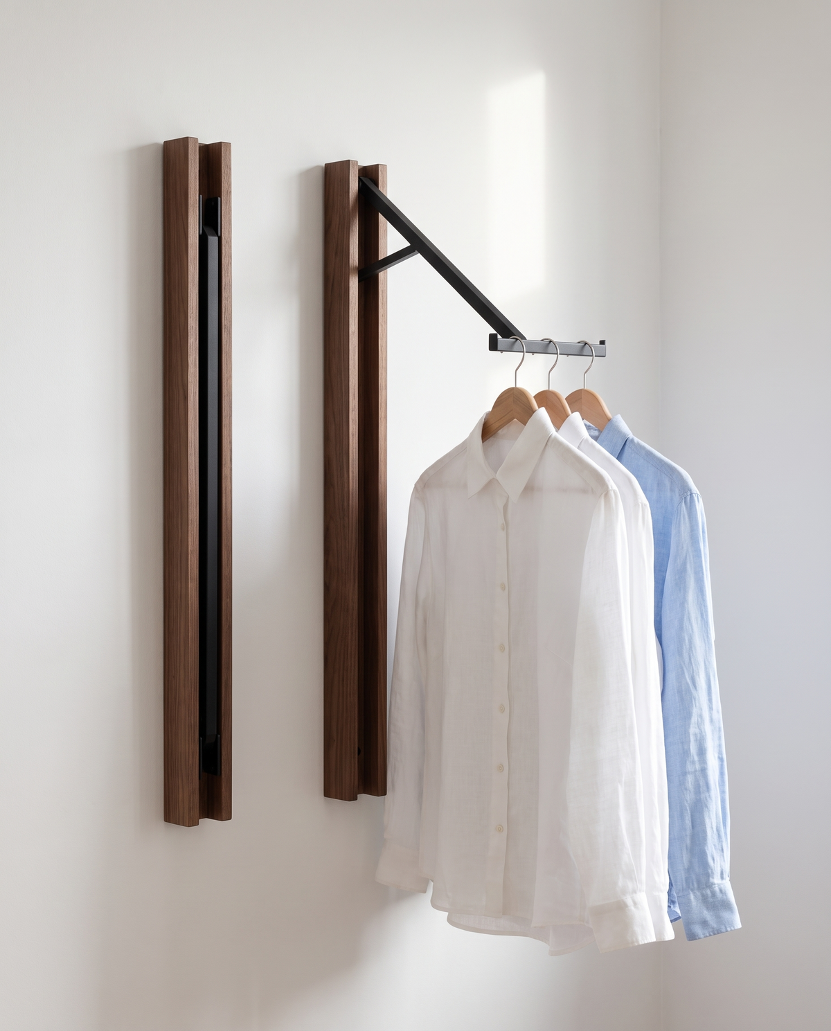 A pair of Kolding hangers on a wall, one open with shirts